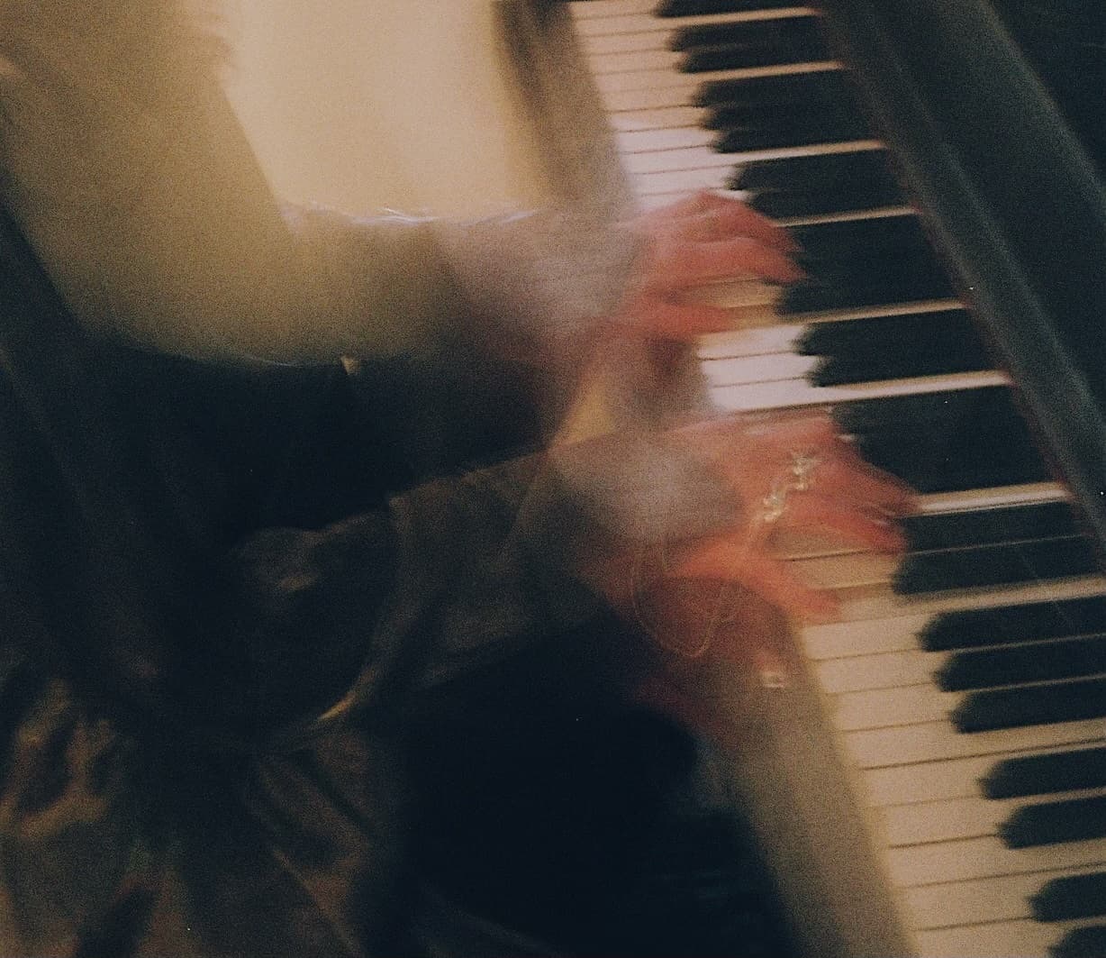 Avery's hands moving across piano keys, blurred with motion